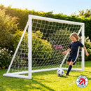 A 6ft by 4ft kids garden football goal made from white weatherproof uPVC, set up on a green lawn.