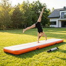 Inflatable gymnastics mat in orange and grey designed for home and gym use