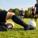 Black shin pads with compression sleeves for football players