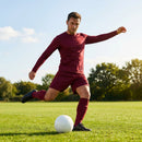 Men's football kit in various colours, including long-sleeve shirt, shorts, and socks