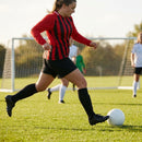 Women's football kit with long-sleeved striped shirt, shorts, and knee-high socks